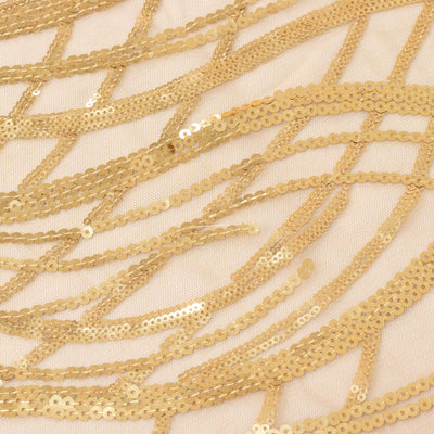 Gold sequin fabric with intricate wave patterns and shimmering details.