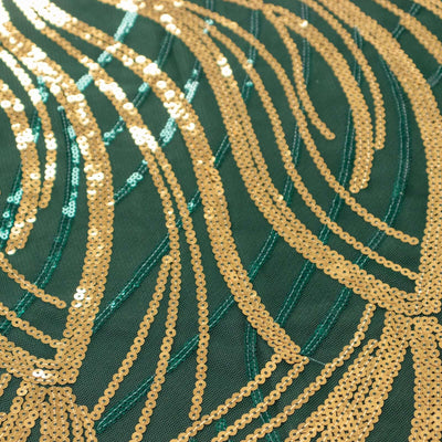 Green fabric with gold sequins in a wavy pattern.