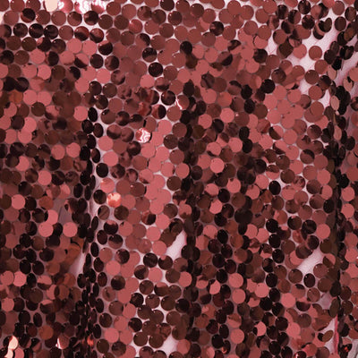 Rose gold sequin fabric with shimmering circular sequins.