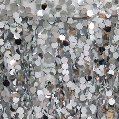 Shiny silver sequins background for festive decorations or crafts.