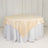 Round table with beige satin tablecloth and white skirt