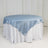 Round table with a light blue satin tablecloth and white skirt.