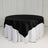 Black satin tablecloth draped over a white table