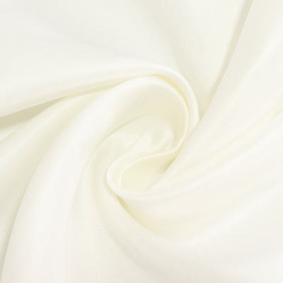 Soft white fabric texture in a swirling pattern.