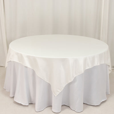 Round table with a white satin tablecloth