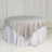 Round table with a beige satin tablecloth draped elegantly.