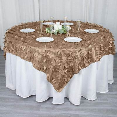 Brown leaf-patterned tablecloth on a round table with elegant decor.