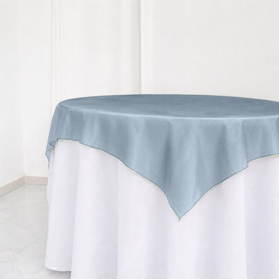 Light blue round tablecloth overlay on white banquet table, elegant event decor