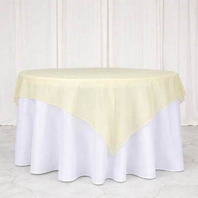 Yellow sheer table overlay on a white tablecloth