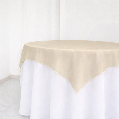 Beige tablecloth draped elegantly over a round table.