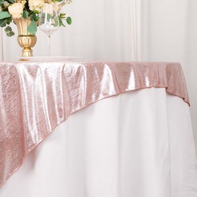 Rose gold sequin tablecloth draped elegantly on a white table.