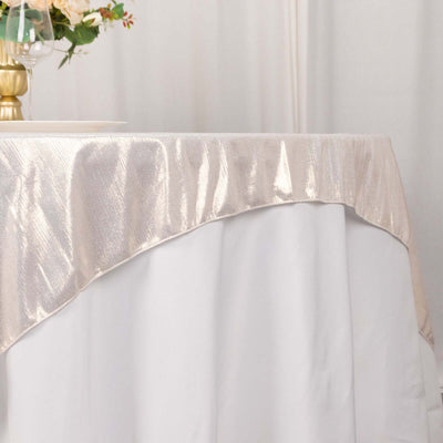 Elegant beige tablecloth draped over a white table for an upscale dining setting.