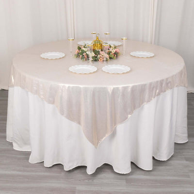 Elegant round table setup with floral centerpiece and decorative plates.