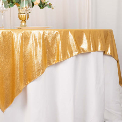 Gold tablecloth draping elegantly over a white table at an event.