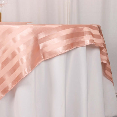Peach satin tablecloth draped elegantly over a white table.