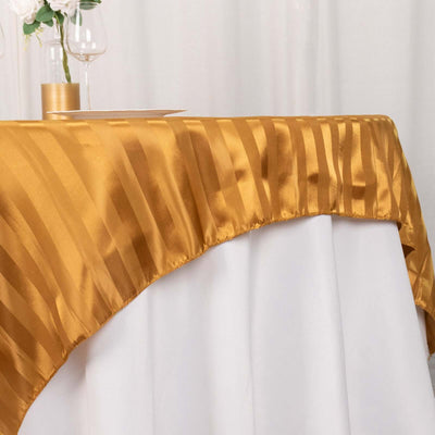 Gold satin tablecloth draped elegantly over a white table.