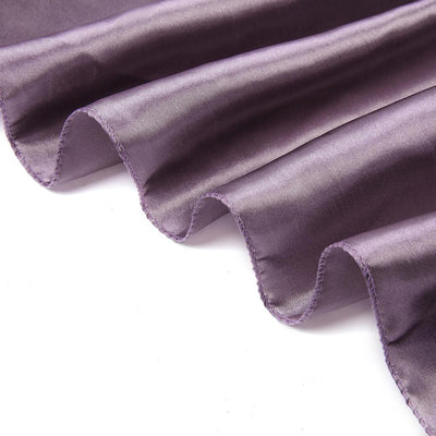 Purple satin fabric with elegant draping and smooth texture.