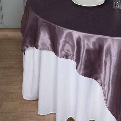 Elegant purple and white tablecloth with a wavy edge.