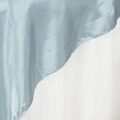 Light blue satin fabric draped elegantly on a plain backdrop.