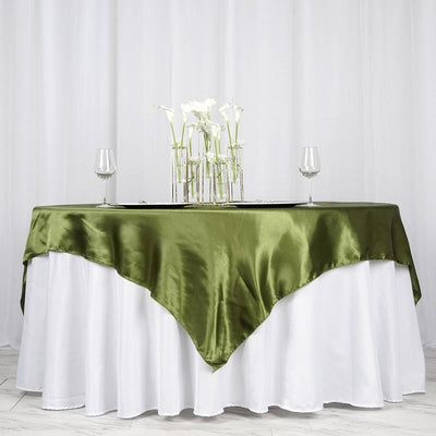 Elegant green satin tablecloth draped over a white table with floral centerpiece.
