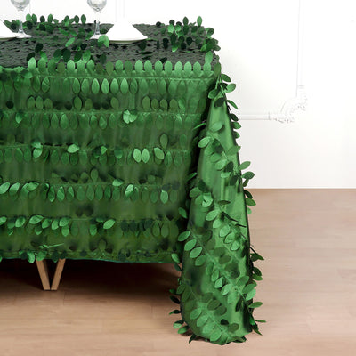 Green leaf-patterned tablecloth draping over a table