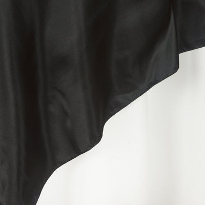 Black satin fabric draped elegantly against a white background