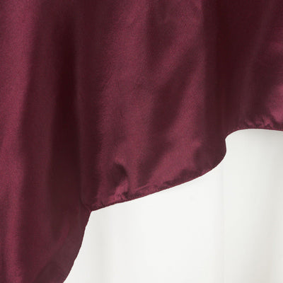 Burgundy satin fabric draped elegantly against a white background.