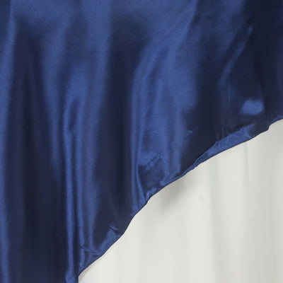 Navy blue satin fabric draped elegantly on a white background.