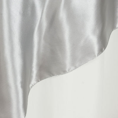 Silver satin fabric draping elegantly with a smooth texture.