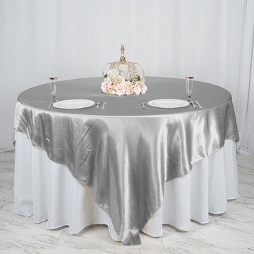 Add a Touch of Elegance with the Silver Seamless Satin Square Table Overlay