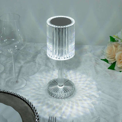 Elegant crystal lamp casting light patterns on a table setting.