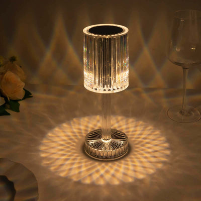 Crystal table lamp casting intricate light patterns.