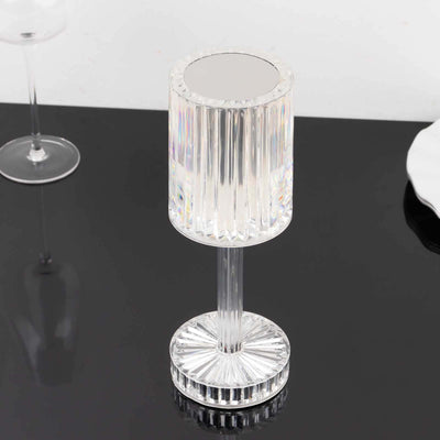 Crystal lamp with a ribbed design and mirrored top on a black surface.