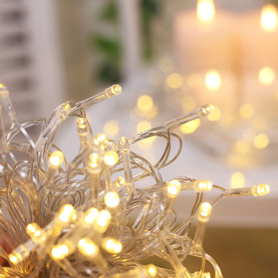 Warm white LED string lights glowing softly in a cozy setting.