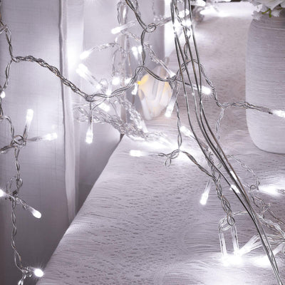 String lights on a white table with a soft background glow.