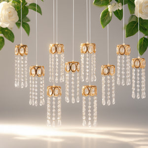 Elegant golden pendant lights with crystal drops on a floral backdrop.