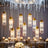 Elegant crystal pendant lights hanging from a decorative ceiling.