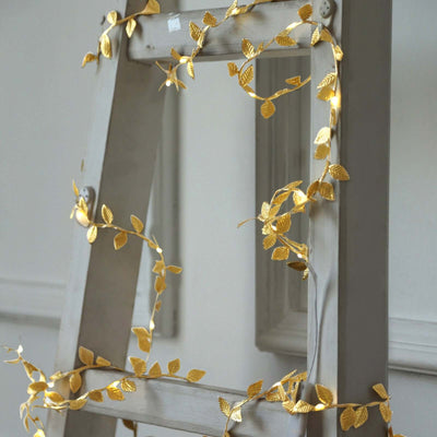 Gold leaf string lights on a decorative ladder.