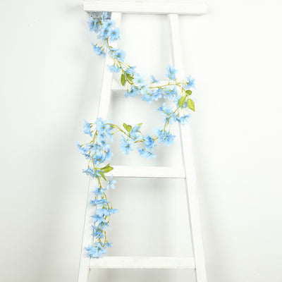 Blue flower garland draped on a white ladder