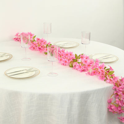 Elegant table setting with pink floral centerpiece and glassware.