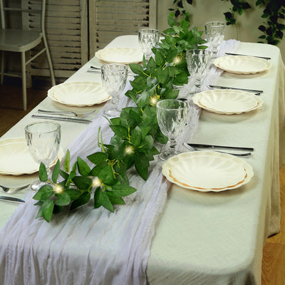 Elegant table setting with greenery, plates, and glassware for a special occasion.