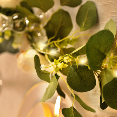 Greenery garland with delicate lights, ideal for decorating events or home spaces.