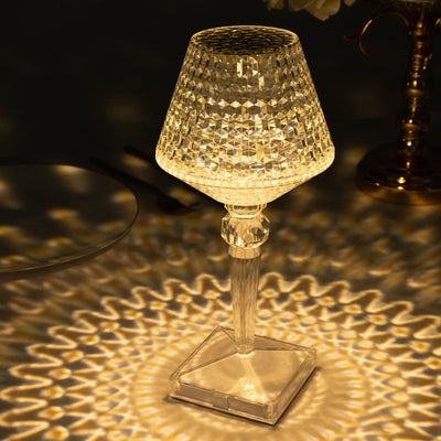 Elegant crystal table lamp casting intricate light patterns.
