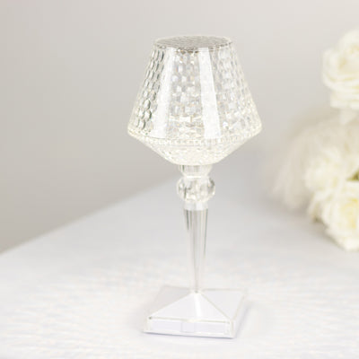 Clear crystal table lamp with geometric design and elegant base.
