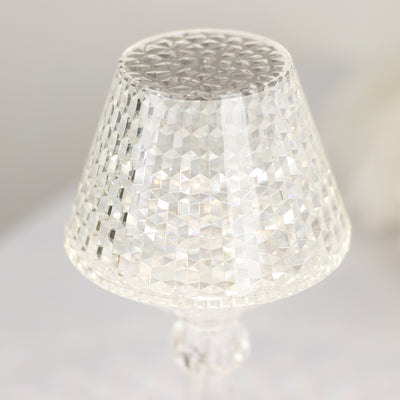 Crystal lamp shade with a geometric pattern reflecting light.