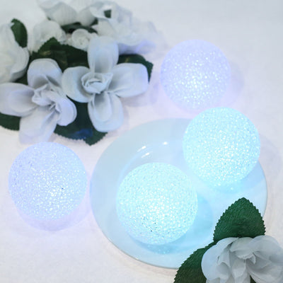 Glowing decorative spheres on a plate with white flowers