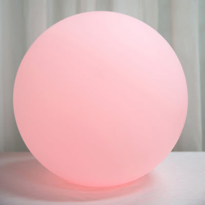 Pink spherical lamp with a soft glow for ambient lighting.