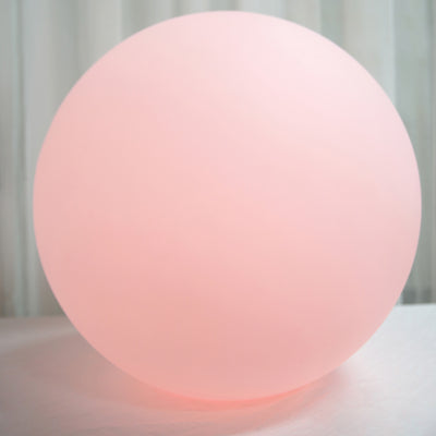 Pink glowing orb on a plain surface.
