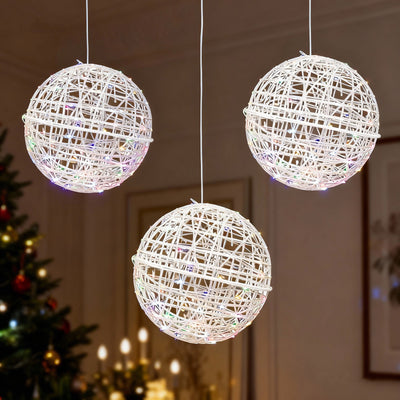 Three decorative hanging light orbs in white wicker design.