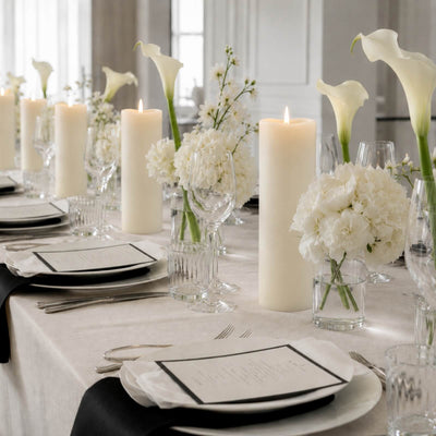 Elegant white wedding table setting with candles and floral centerpieces